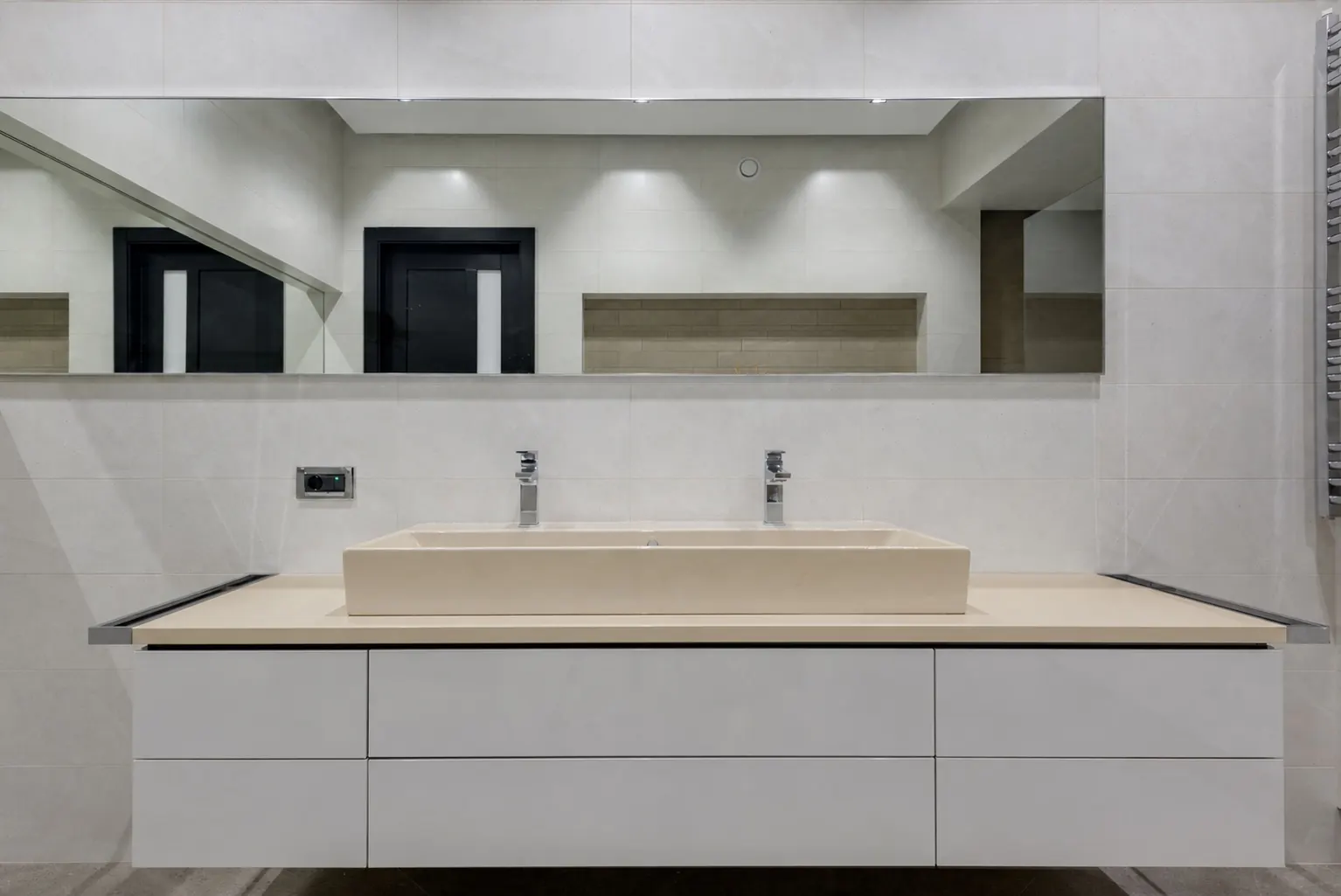 Double-faucet vanity with a dated beige top and basin before refinishing